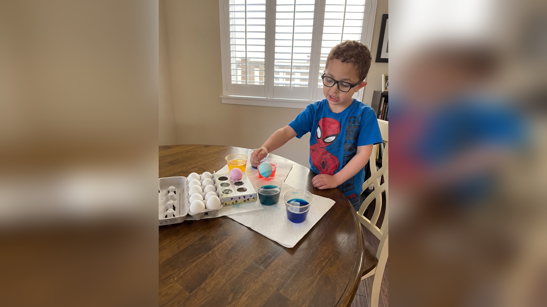 Child dyeing eggs during a craft activity